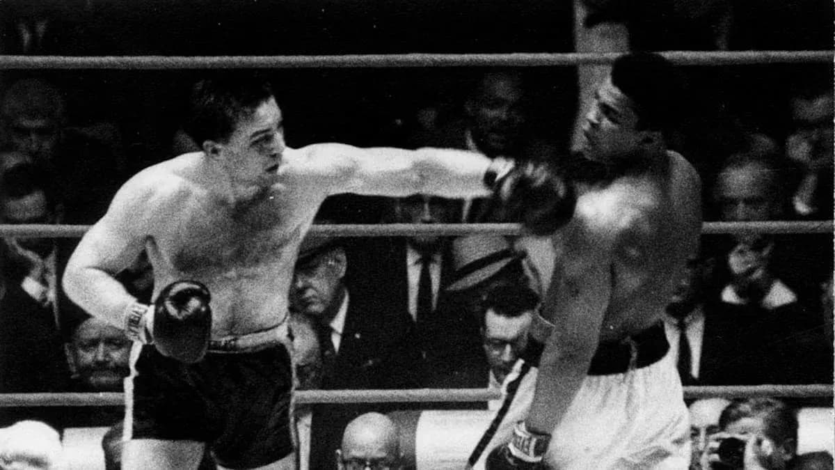 Boxers exchanging punches in a boxing match Boxers exchanging punches in a boxing match