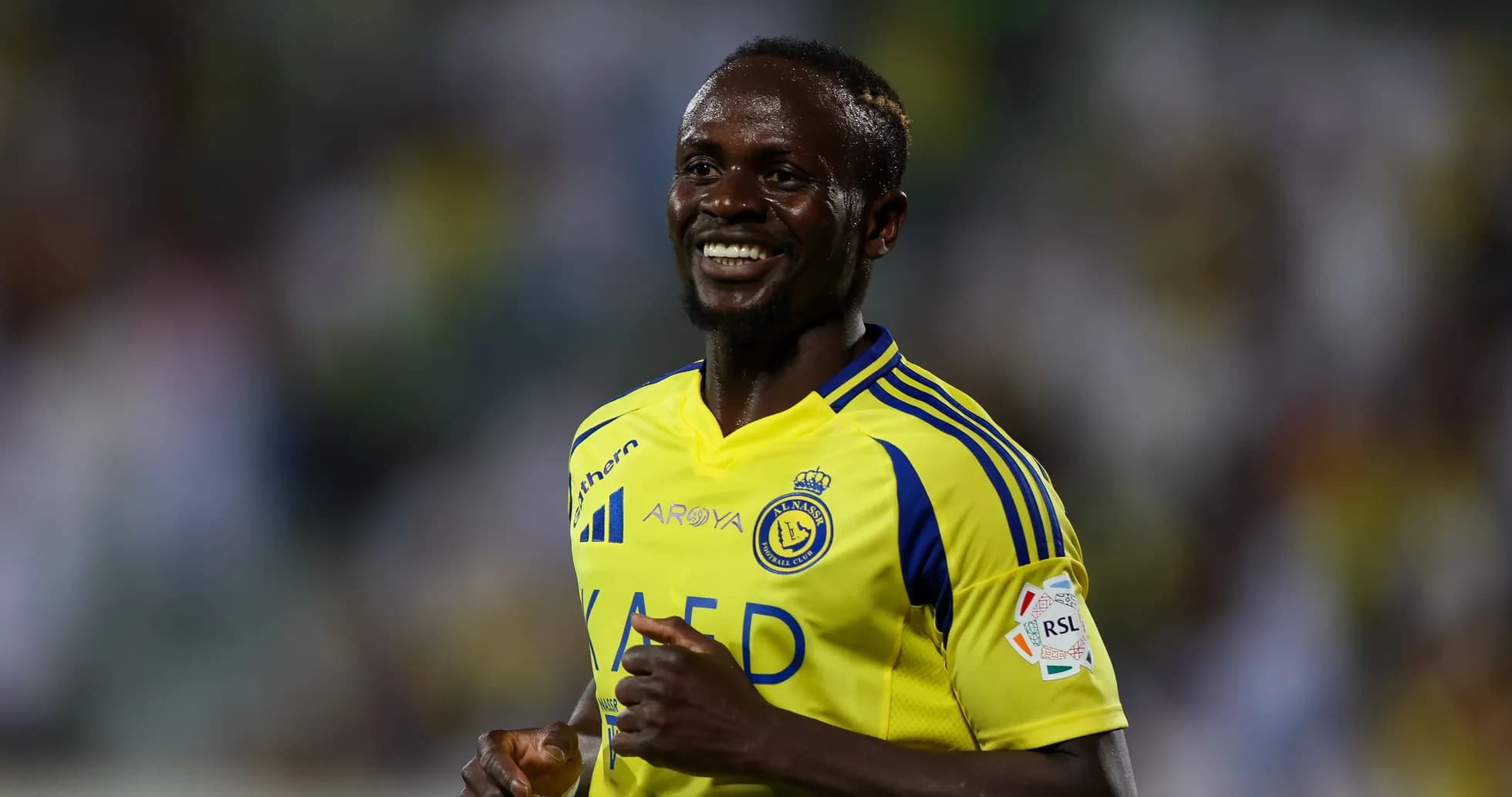 Player celebrating in Al Nassr yellow jersey Player celebrating in Al Nassr yellow jersey