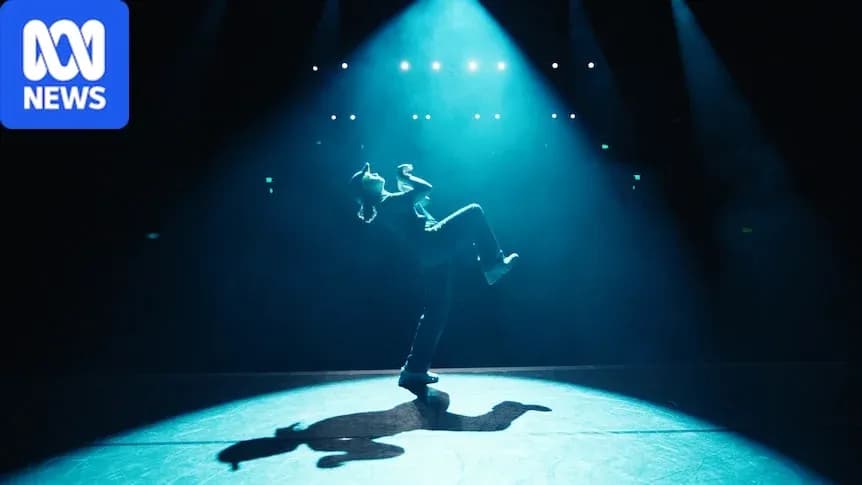 Dancer performing on stage under spotlight Dancer performing on stage under spotlight