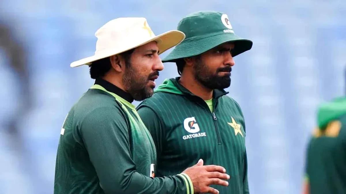 Two Pakistan cricket players in training gear talking Two Pakistan cricket players in training gear talking