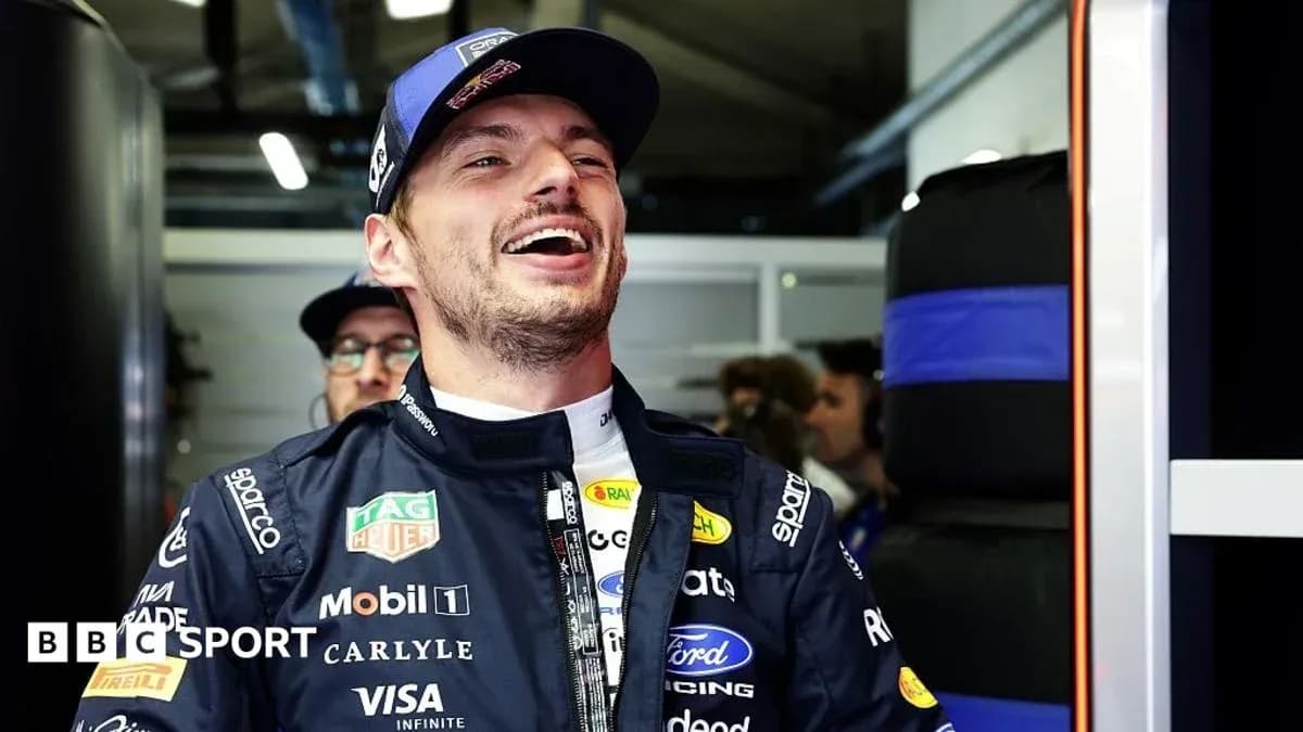 Driver smiling in team garage before race Driver smiling in team garage before race