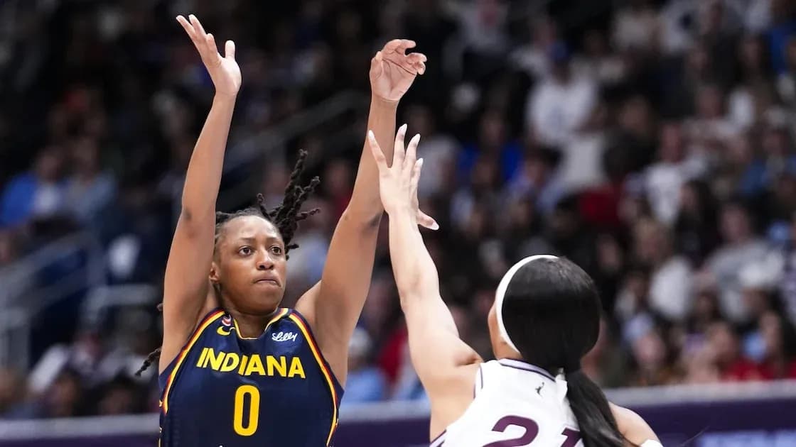 Indiana player shooting over defender during game Indiana player shooting over defender during game