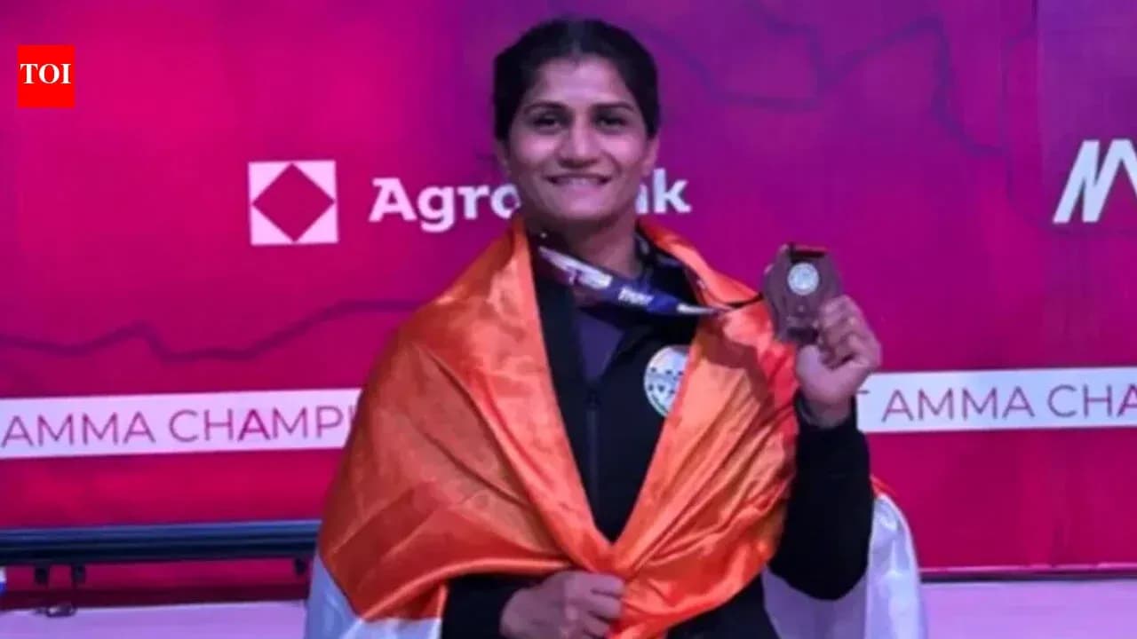 Athlete holding medal and draped in flag Athlete holding medal and draped in flag