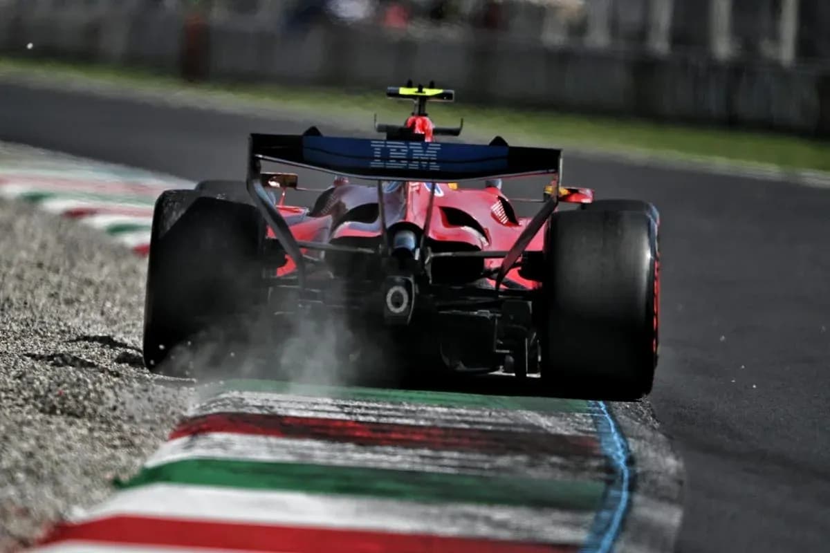 Red Formula 1 car on track with tire smoke Red Formula 1 car on track with tire smoke