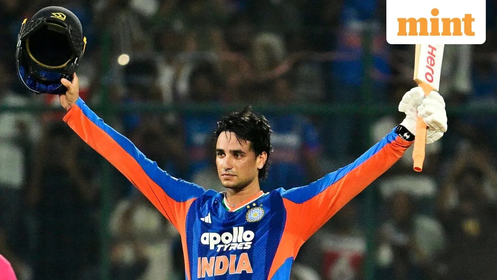 Cricketer celebrating a milestone with helmet and bat Cricketer celebrating a milestone with helmet and bat
