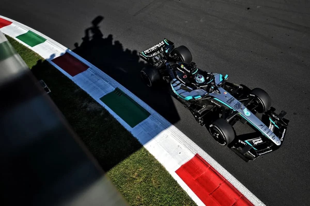 Formula 1 car navigating a corner on track Formula 1 car navigating a corner on track