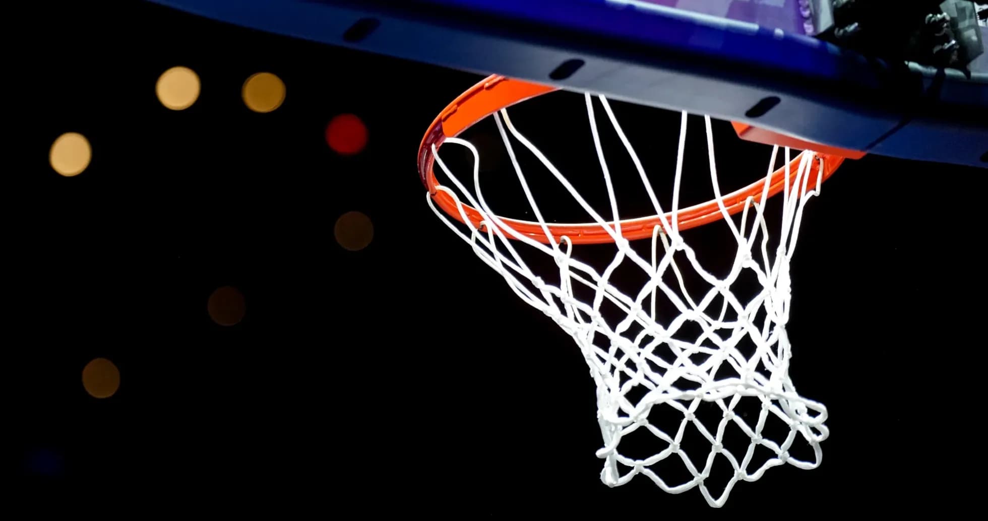 Basketball hoop with net against dark background Basketball hoop with net against dark background