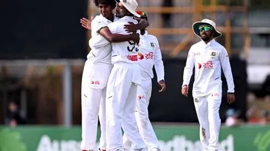 Players celebrating after taking a wicket during match Players celebrating after taking a wicket during match