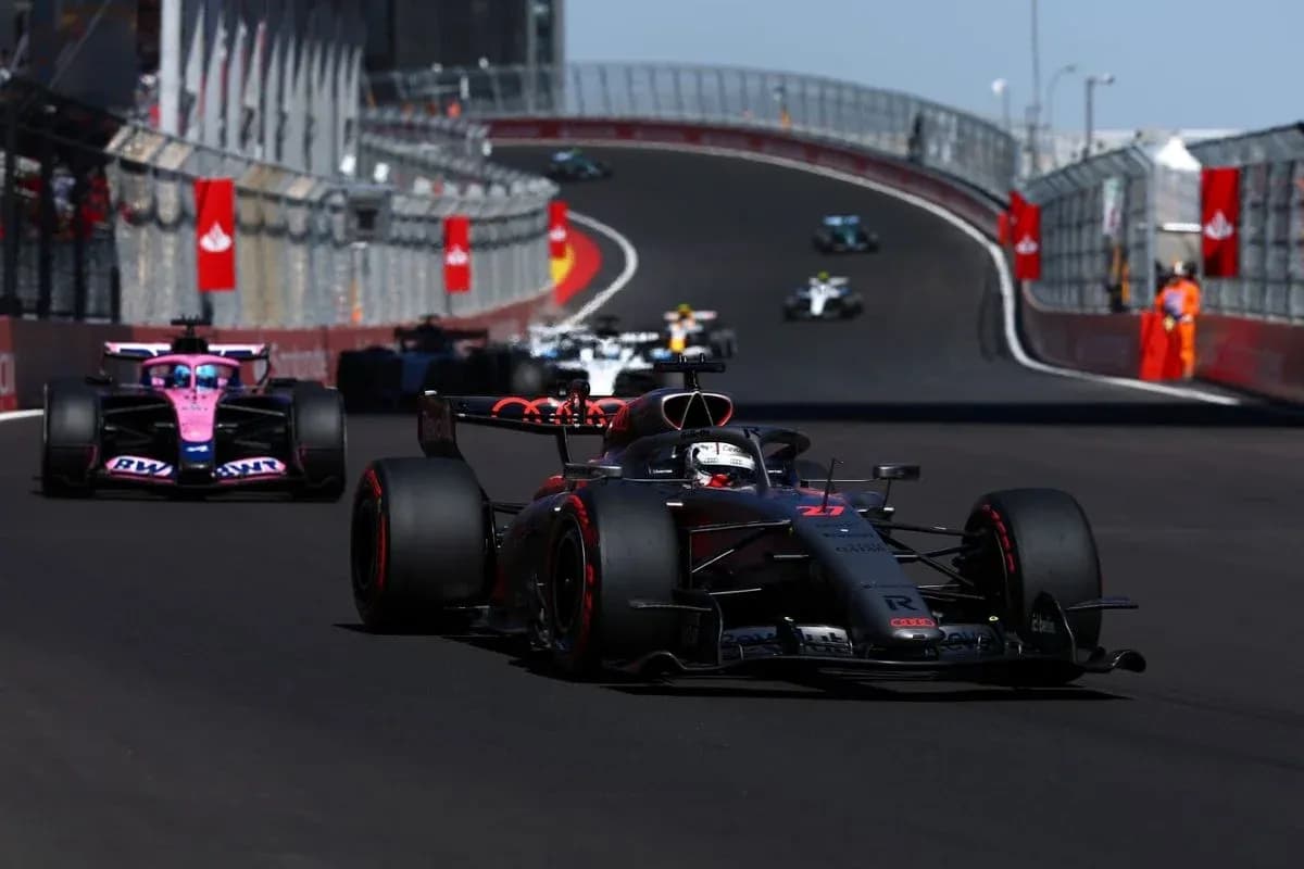 Formula 1 cars racing on a circuit track Formula 1 cars racing on a circuit track