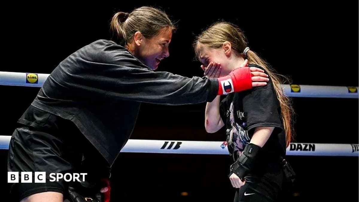 Boxer mentoring young girl in training ring Boxer mentoring young girl in training ring