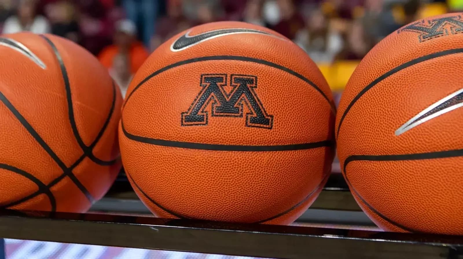 Three basketballs with Minnesota logo on bench Three basketballs with Minnesota logo on bench