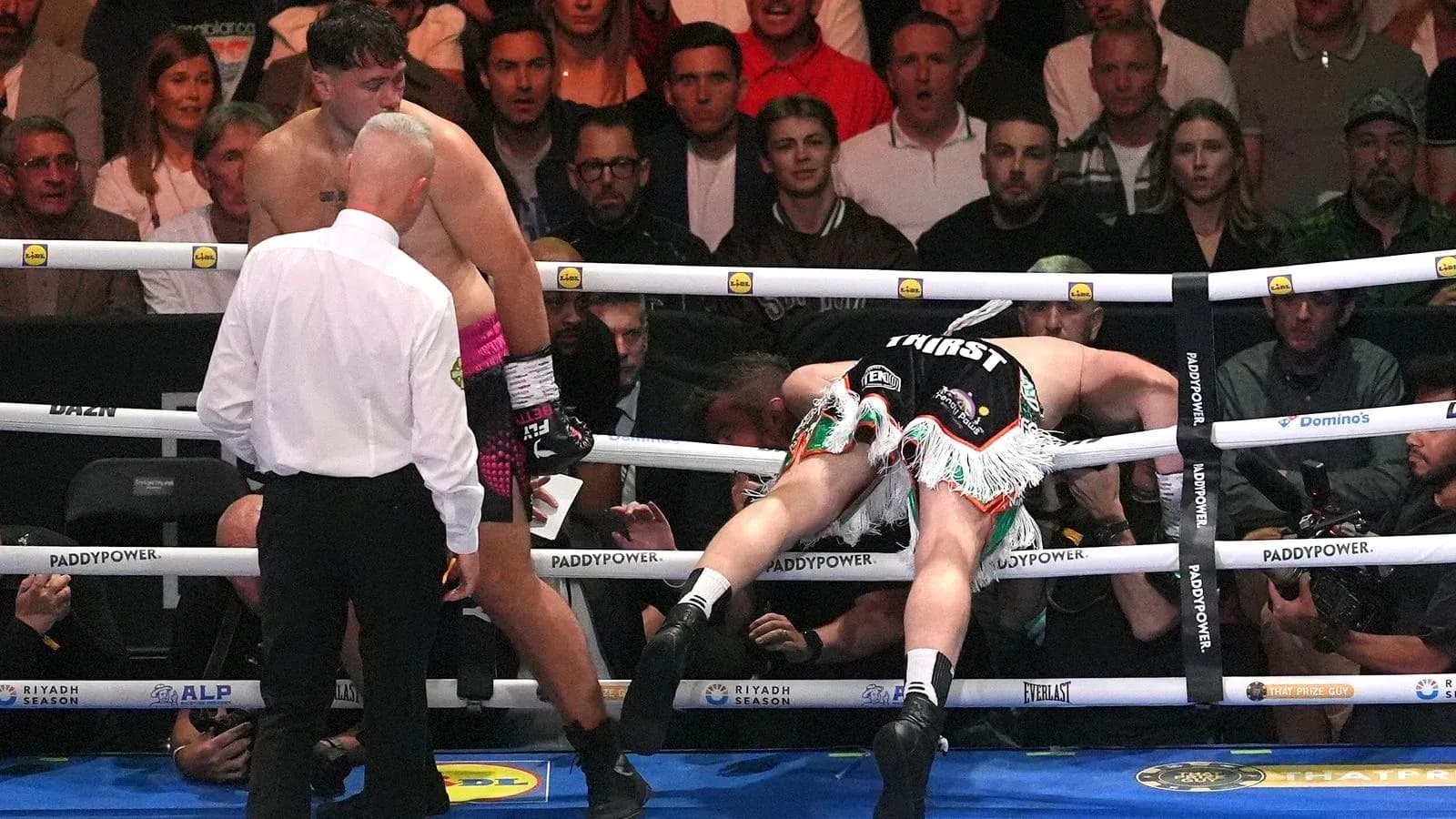 Boxer knocked down, referee checking on him Boxer knocked down, referee checking on him