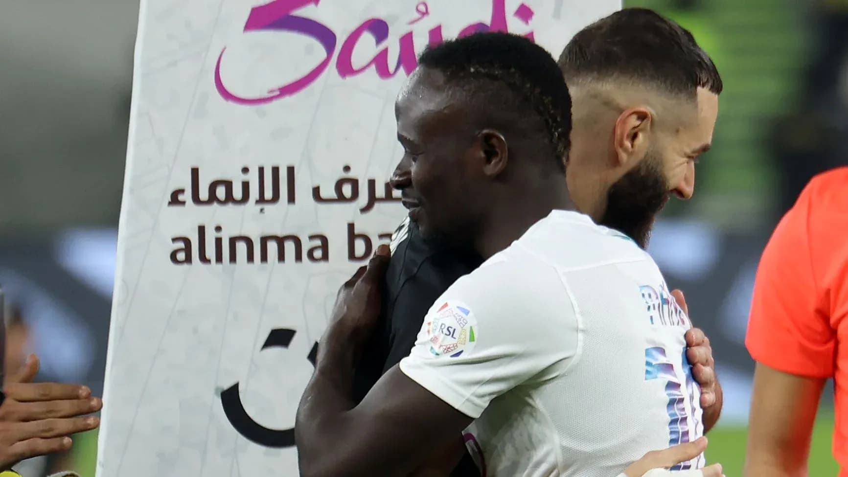 Players embracing after a match, team logos visible Players embracing after a match, team logos visible