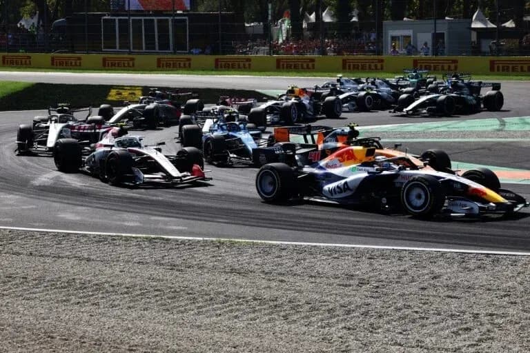 Multiple Formula 1 cars racing on track Multiple Formula 1 cars racing on track