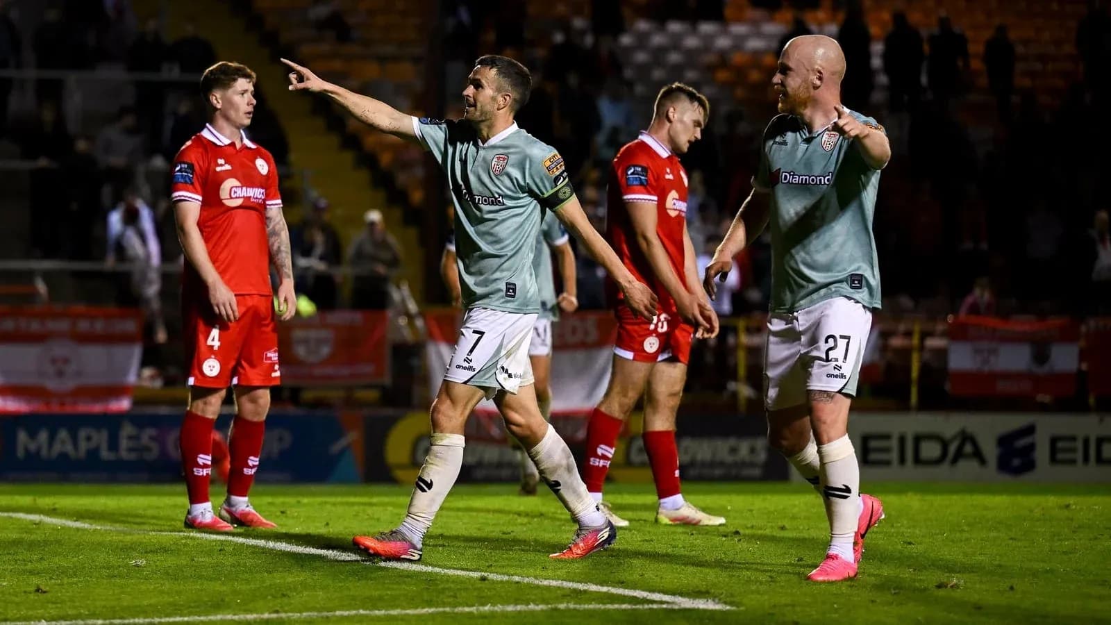 Players celebrating after scoring a goal during match Players celebrating after scoring a goal during match