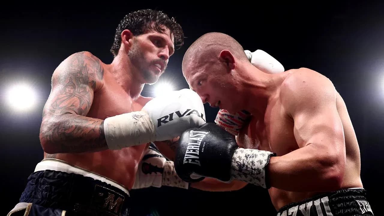 Two boxers exchanging punches in the ring Two boxers exchanging punches in the ring