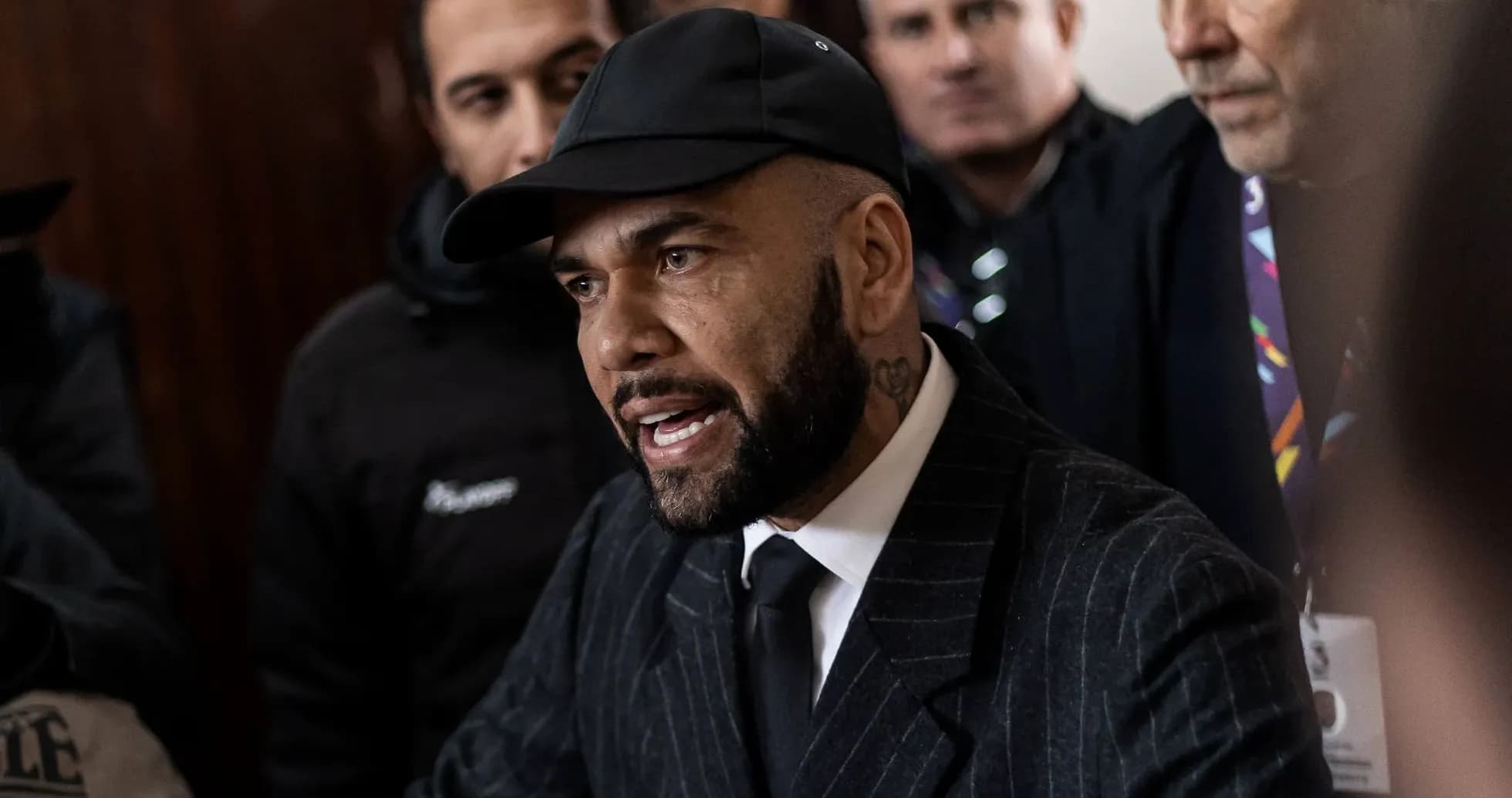 Man speaking surrounded by a crowd of people Man speaking surrounded by a crowd of people