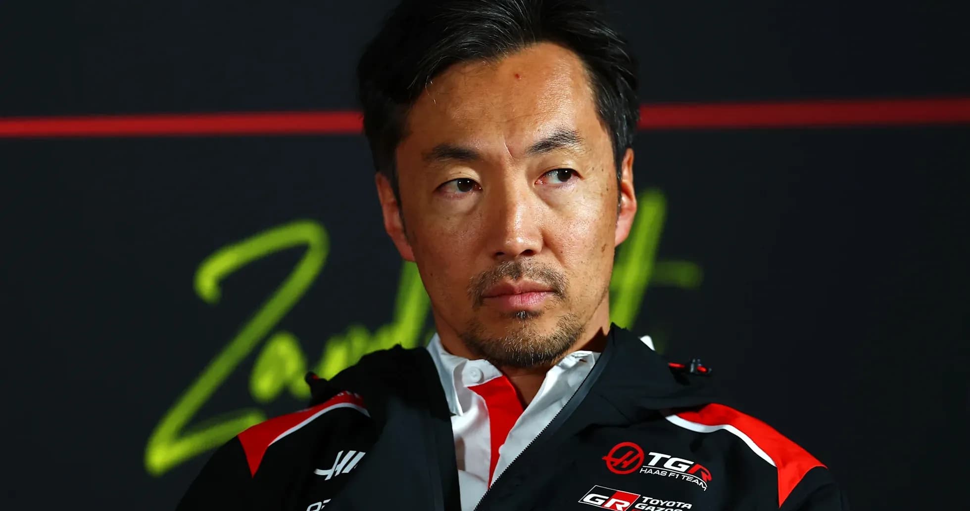 Man in team jacket during press conference Man in team jacket during press conference