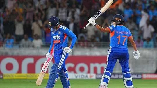 Two cricket players on the field during match Two cricket players on the field during match