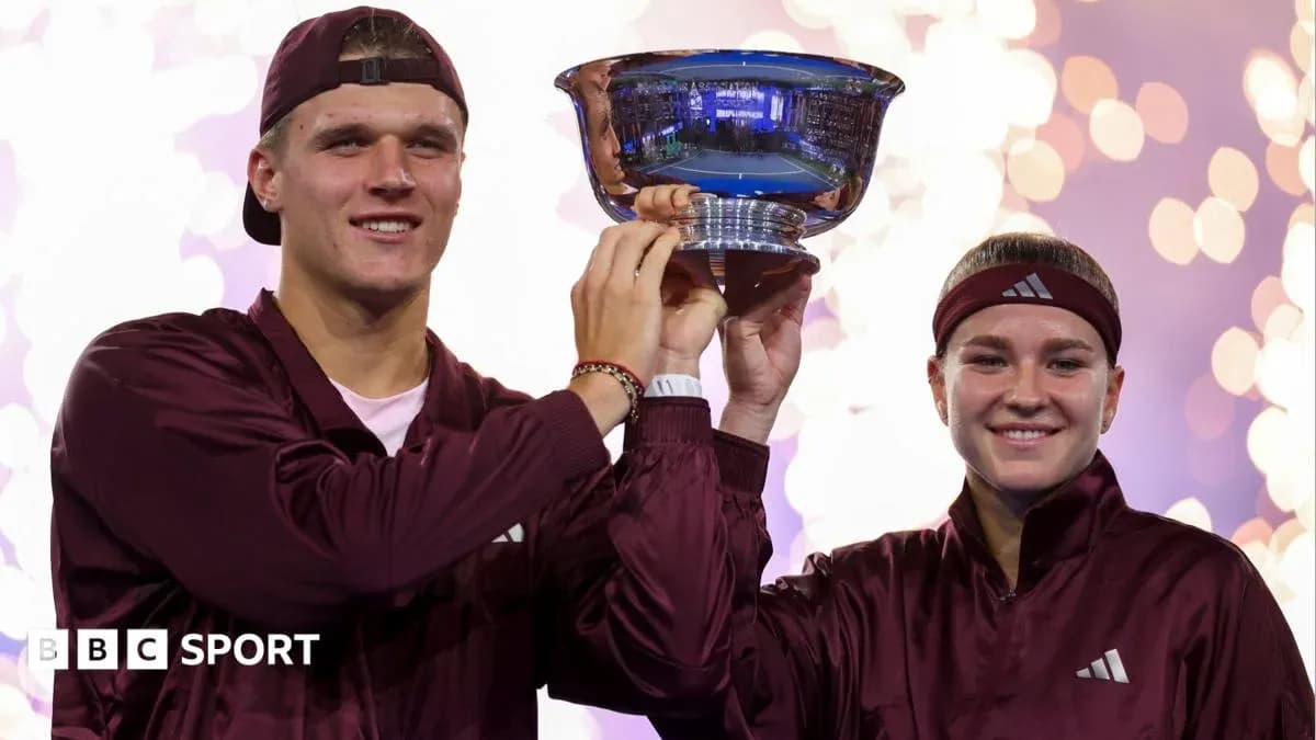 Two athletes celebrating victory by holding trophy Two athletes celebrating victory by holding trophy