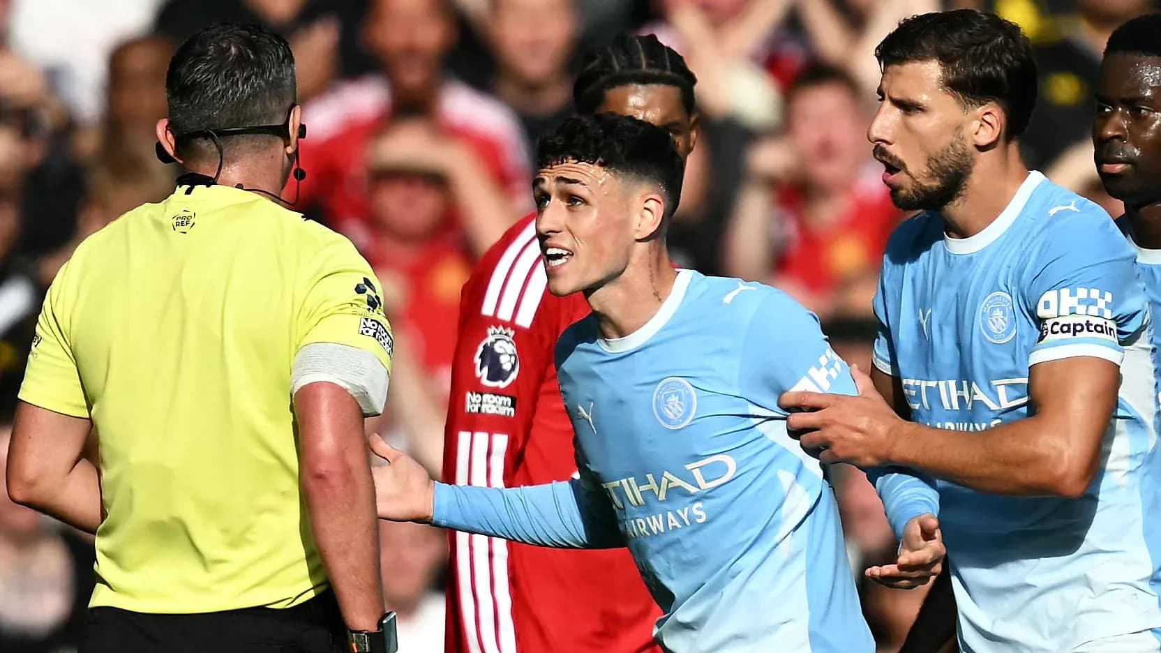 Phil Foden arguing with referee during match Phil Foden arguing with referee during match