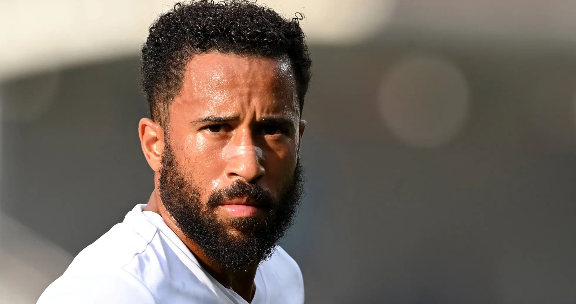 Player with beard and bandage on nose looking ahead Player with beard and bandage on nose looking ahead