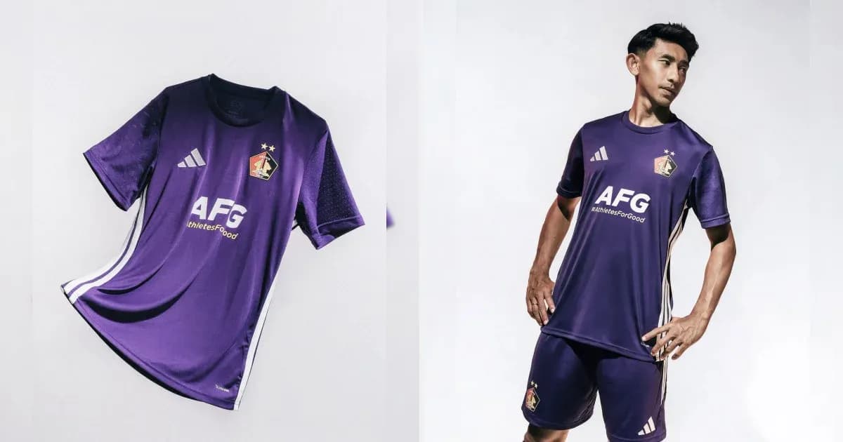 Purple football kit displayed and modeled by player Purple football kit displayed and modeled by player