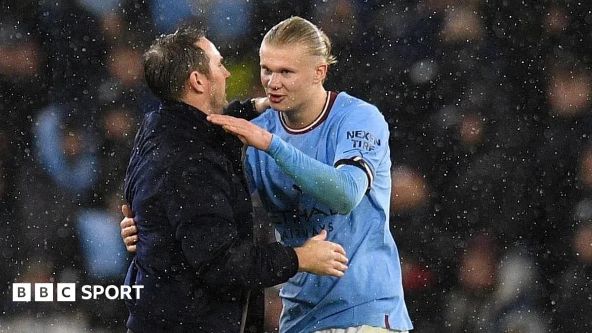 Player and coach embracing in the rain Player and coach embracing in the rain