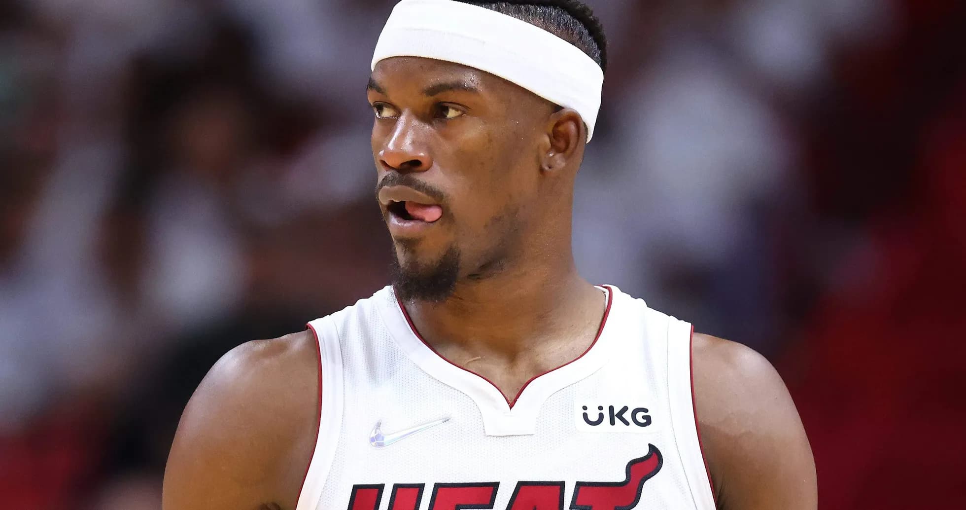 Basketball player in Miami Heat uniform on court Basketball player in Miami Heat uniform on court