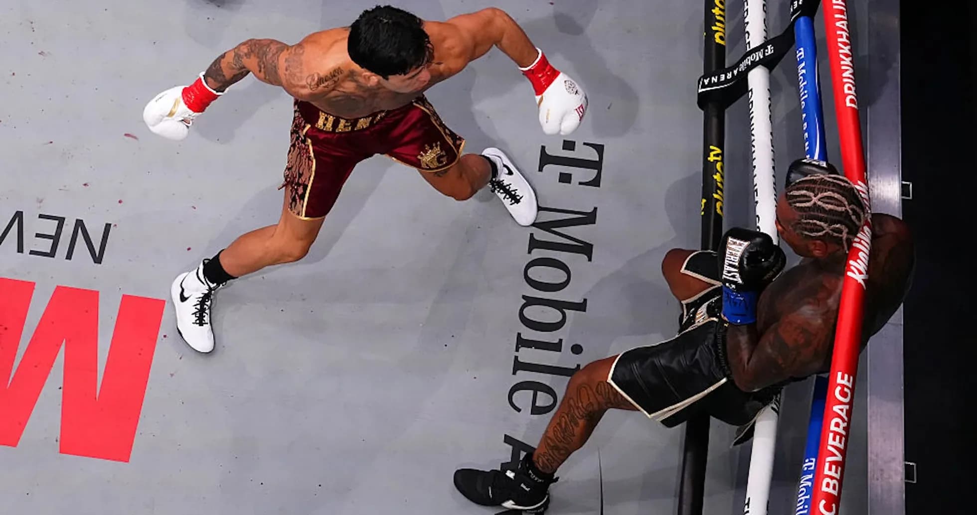 Boxer delivering punch to opponent in ring Boxer delivering punch to opponent in ring