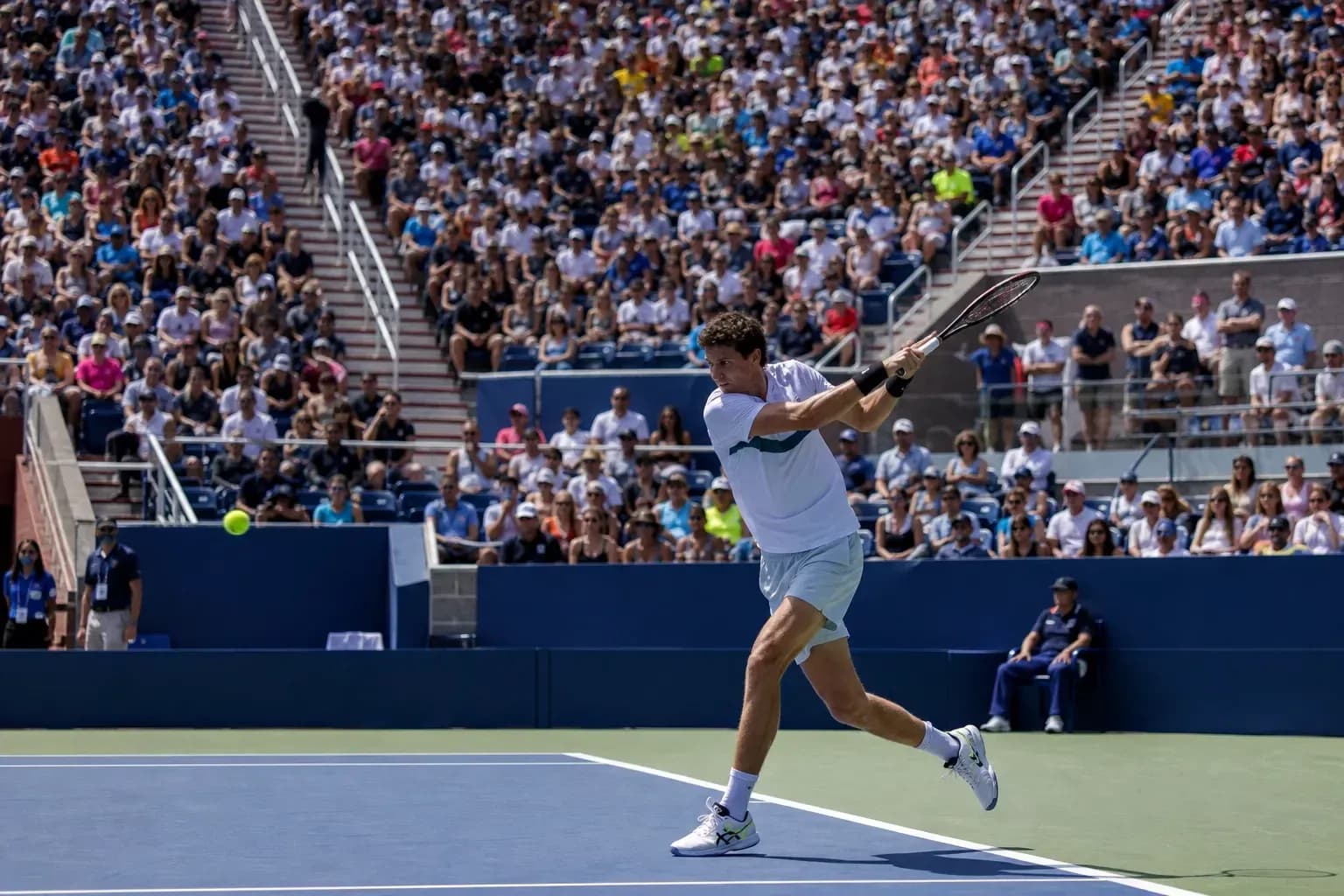 Player hitting a forehand during tennis match Player hitting a forehand during tennis match