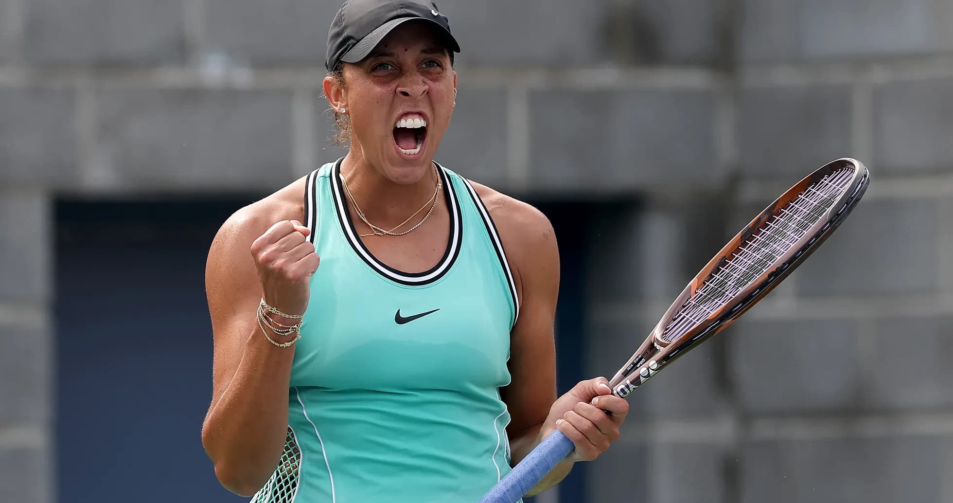 Tennis player celebrating with racket on court Tennis player celebrating with racket on court