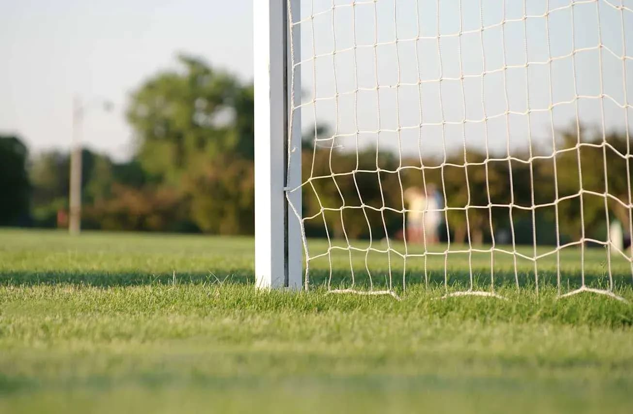 Soccer goalpost and net on grassy field Soccer goalpost and net on grassy field