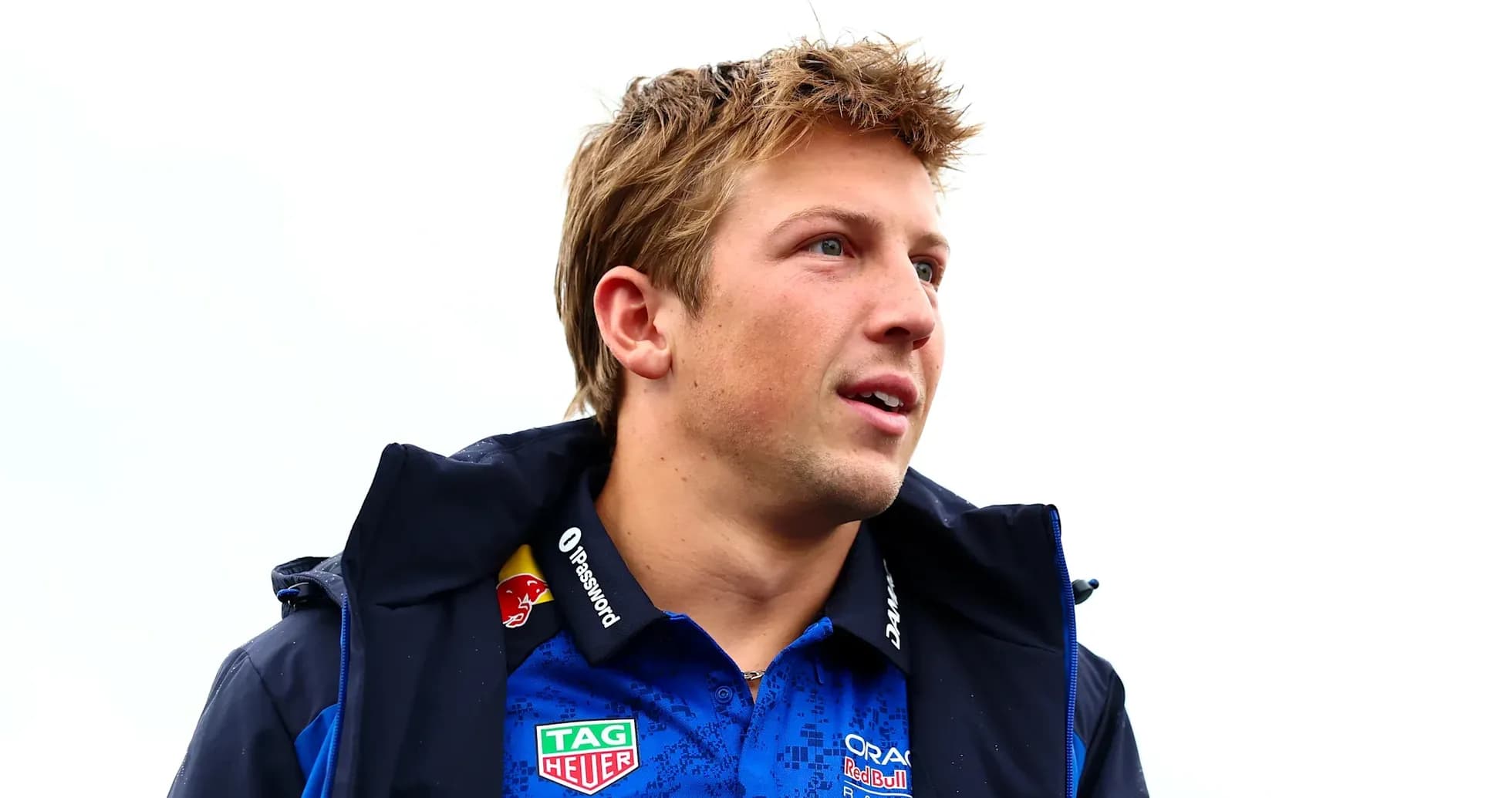 Man in blue racing team jacket looking to the side Man in blue racing team jacket looking to the side
