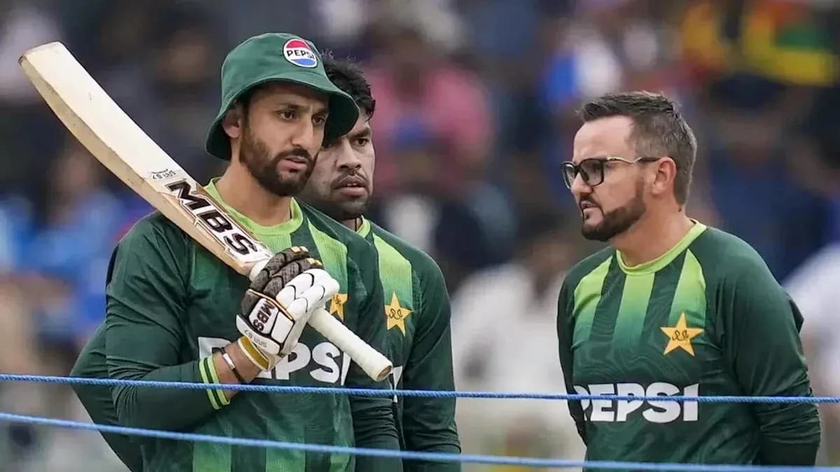 Pakistani cricket players discussing strategy on field Pakistani cricket players discussing strategy on field