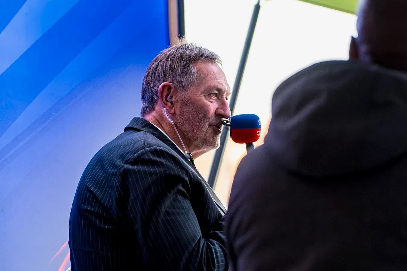 Commentator speaking into microphone during broadcast Commentator speaking into microphone during broadcast