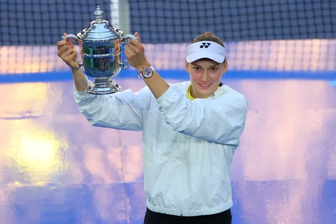 Player holding trophy on tennis court after victory Player holding trophy on tennis court after victory