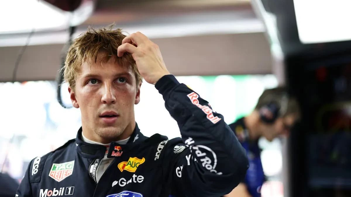 Driver adjusting hair in racing garage before event Driver adjusting hair in racing garage before event