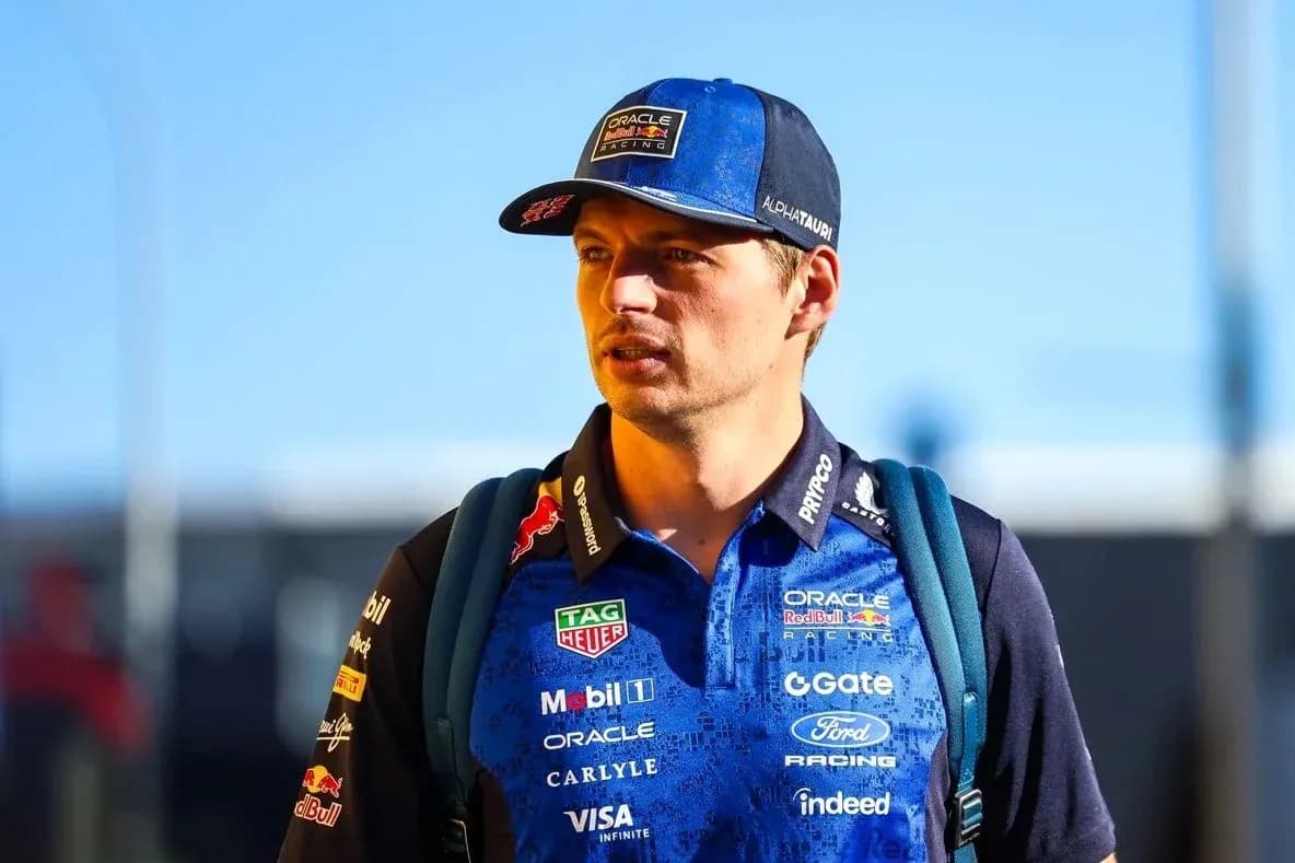 Driver wearing team gear walking towards camera Driver wearing team gear walking towards camera