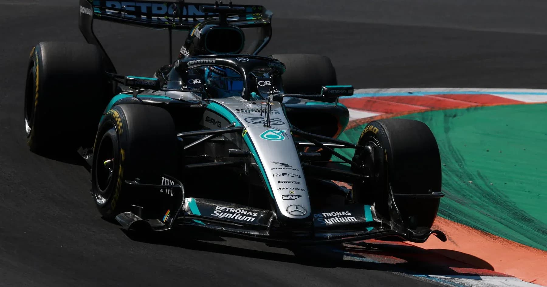 Mercedes F1 car navigating a track corner Mercedes F1 car navigating a track corner
