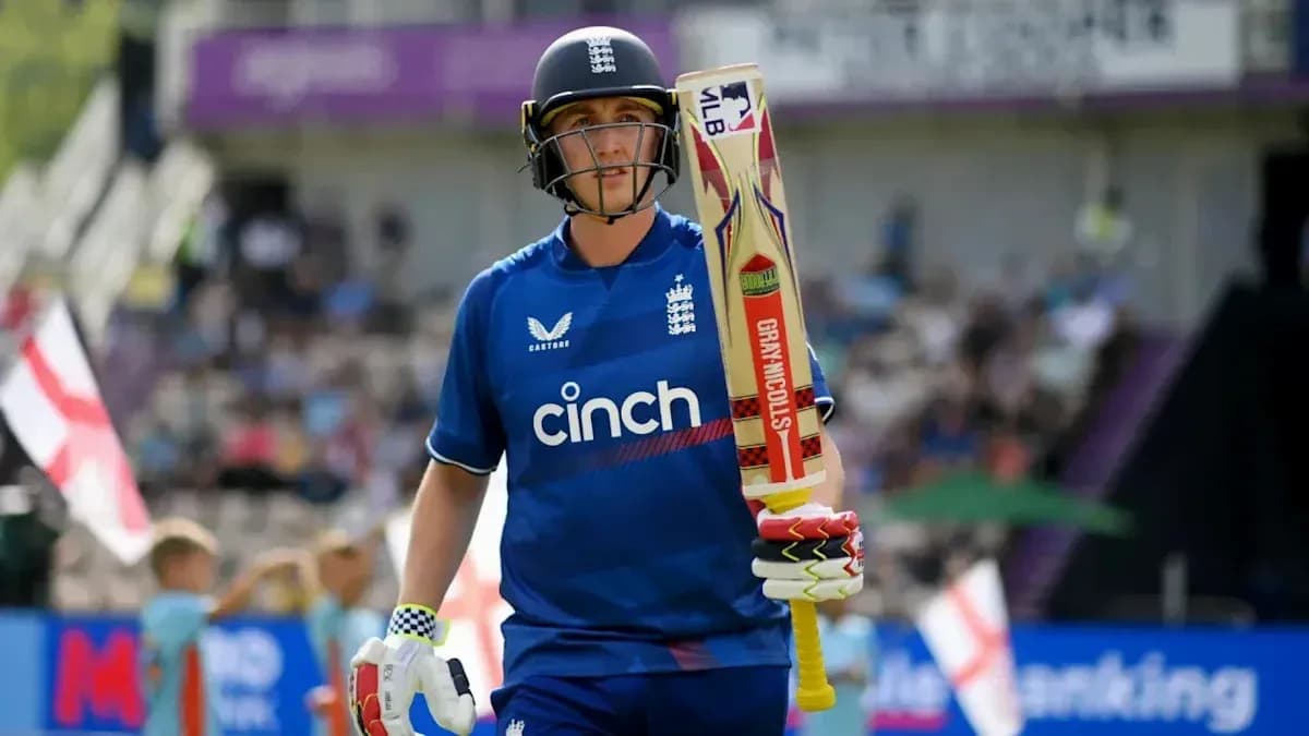 Cricketer walking with bat during match Cricketer walking with bat during match