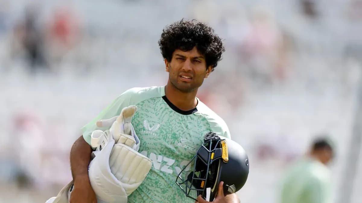 Cricketer carrying gear during warm-up session Cricketer carrying gear during warm-up session