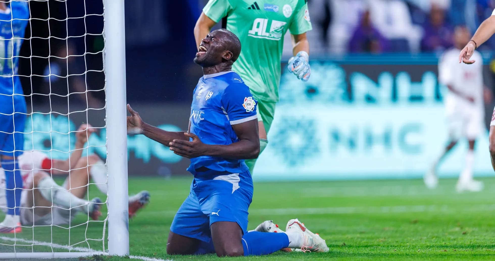 Player kneeling near goalpost after missing chance Player kneeling near goalpost after missing chance