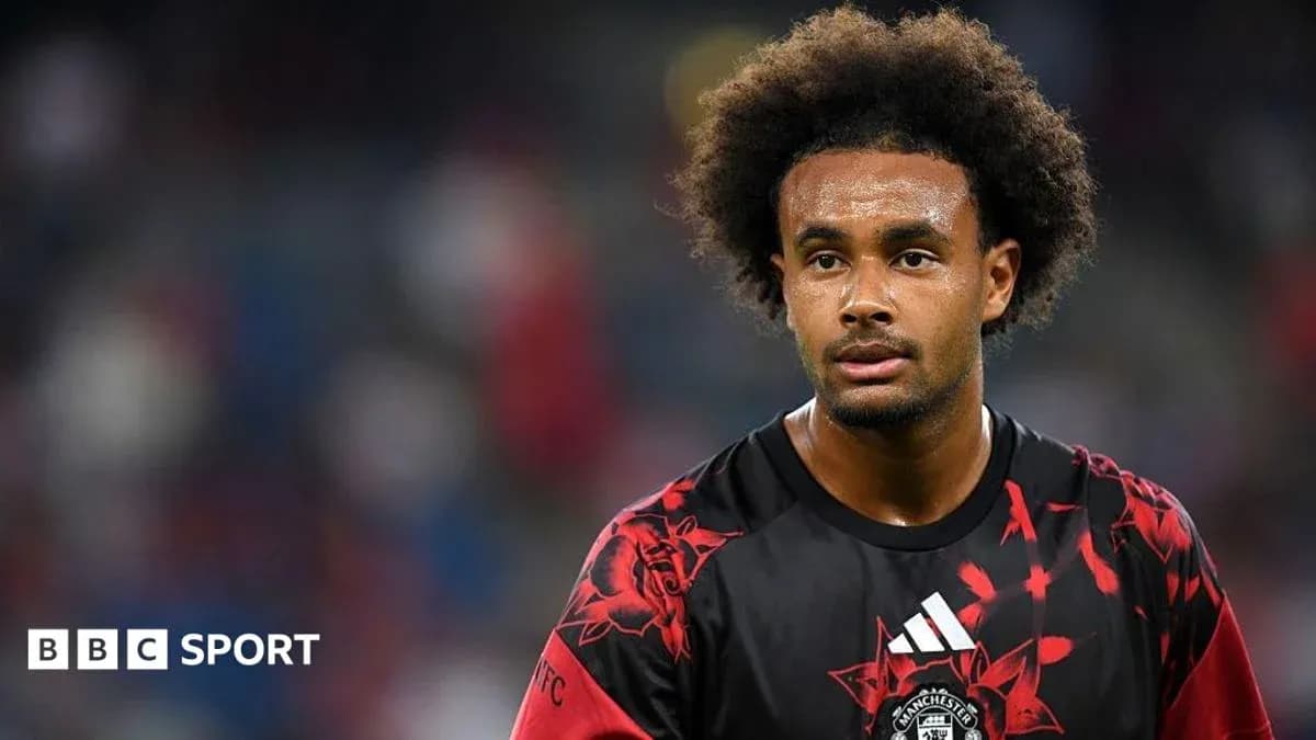 Player in red and black jersey during match Player in red and black jersey during match