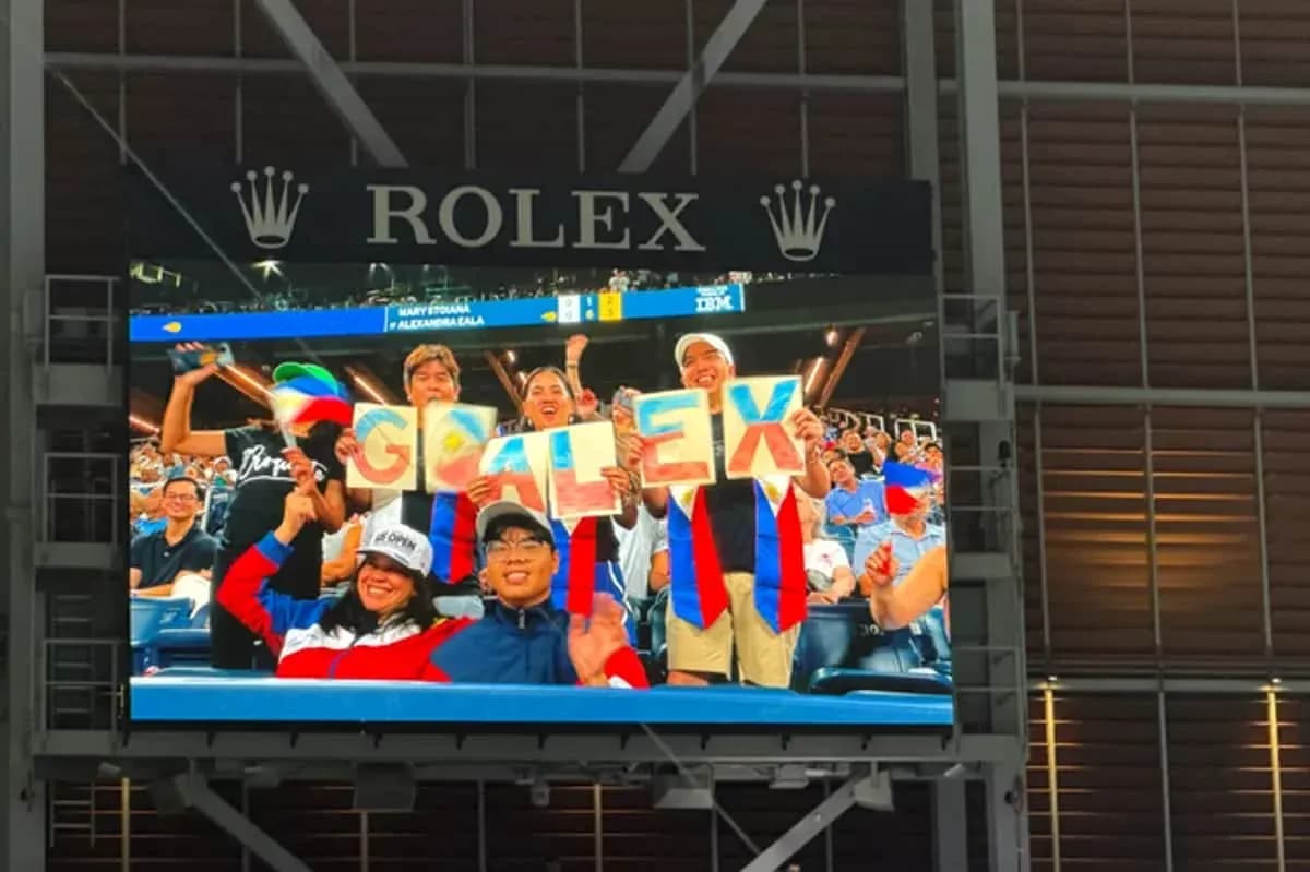 Fans cheering and holding 'GO ALEX' signs Fans cheering and holding 'GO ALEX' signs