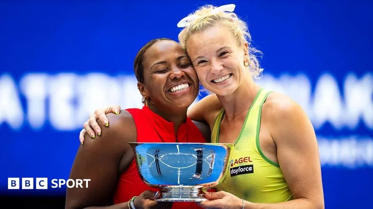 Two tennis players celebrating with trophy after match Two tennis players celebrating with trophy after match