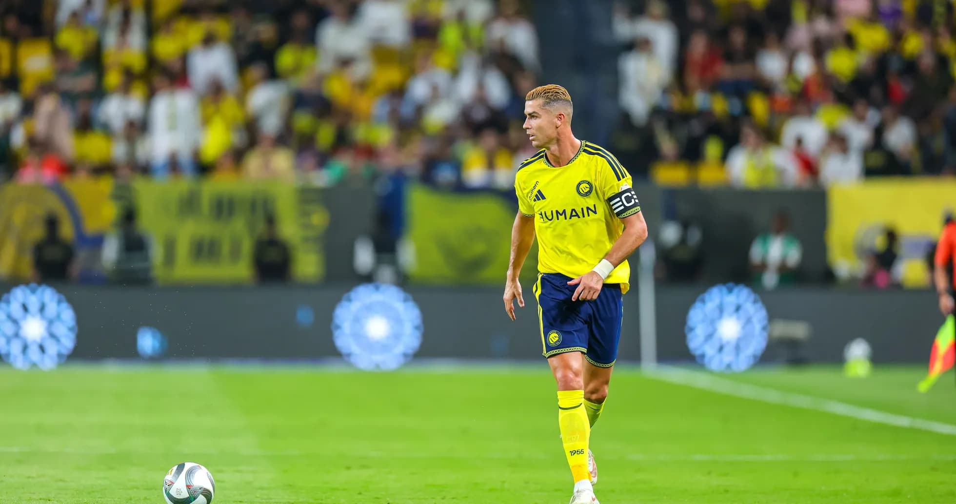 Player in yellow uniform running with soccer ball Player in yellow uniform running with soccer ball
