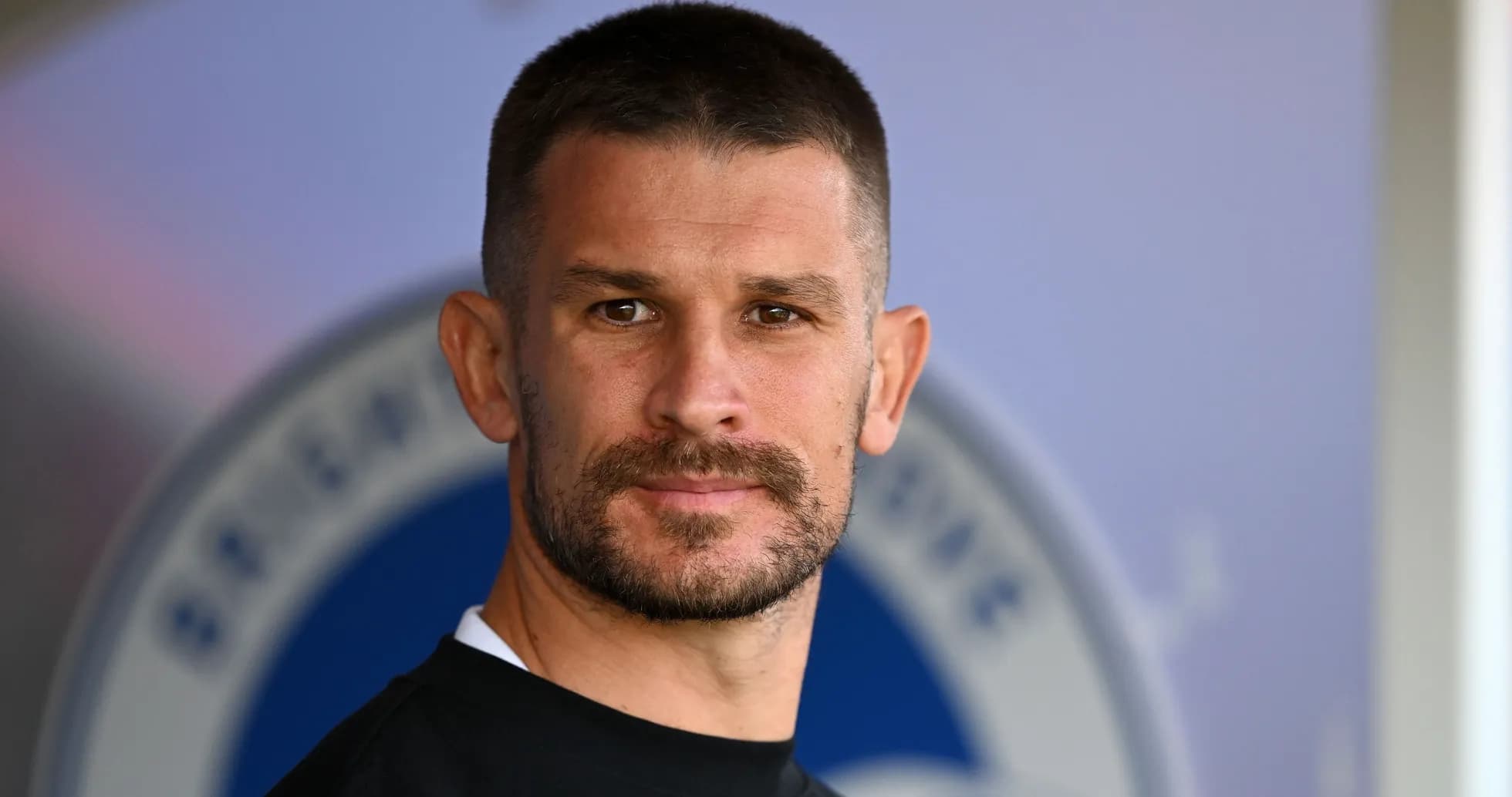 Man with short hair and beard posing for camera Man with short hair and beard posing for camera