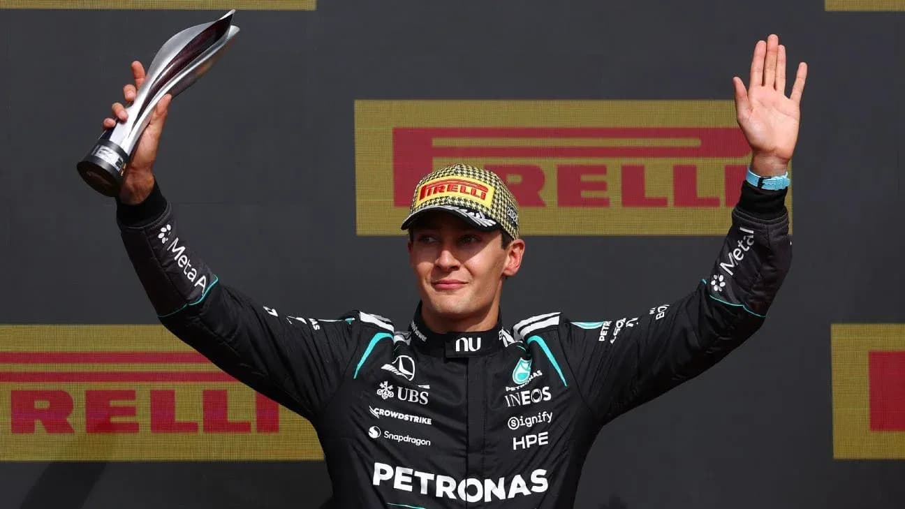 Driver celebrating with trophy on podium Driver celebrating with trophy on podium