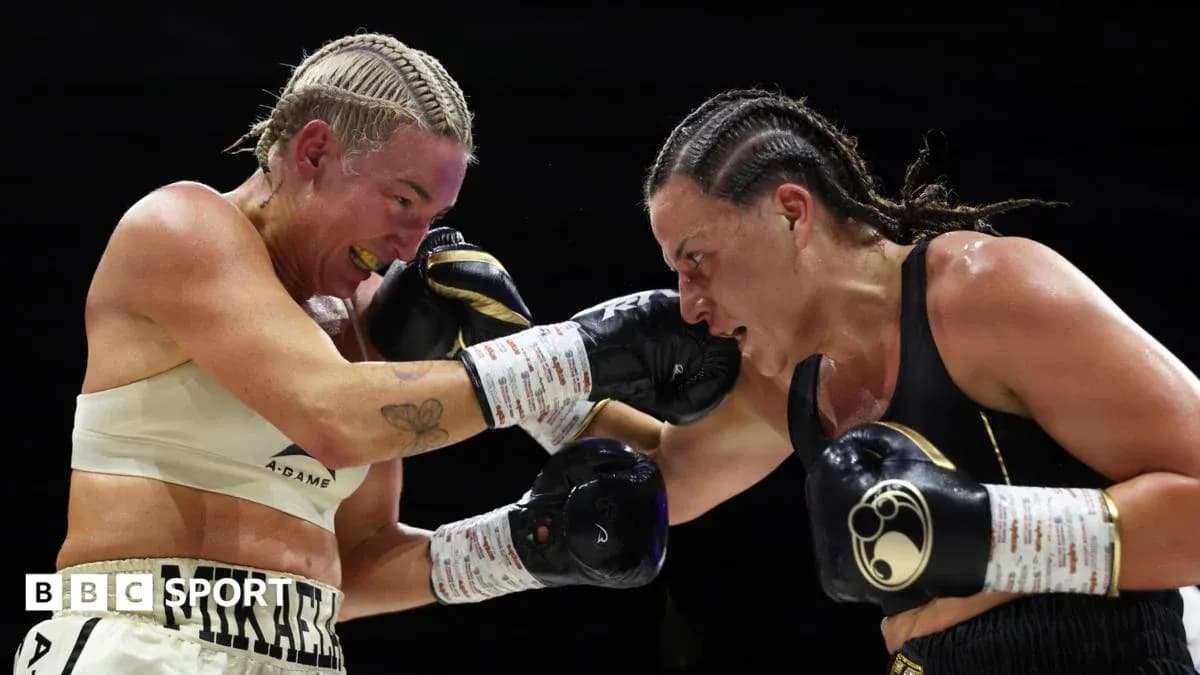 Two female boxers exchanging punches in the ring Two female boxers exchanging punches in the ring
